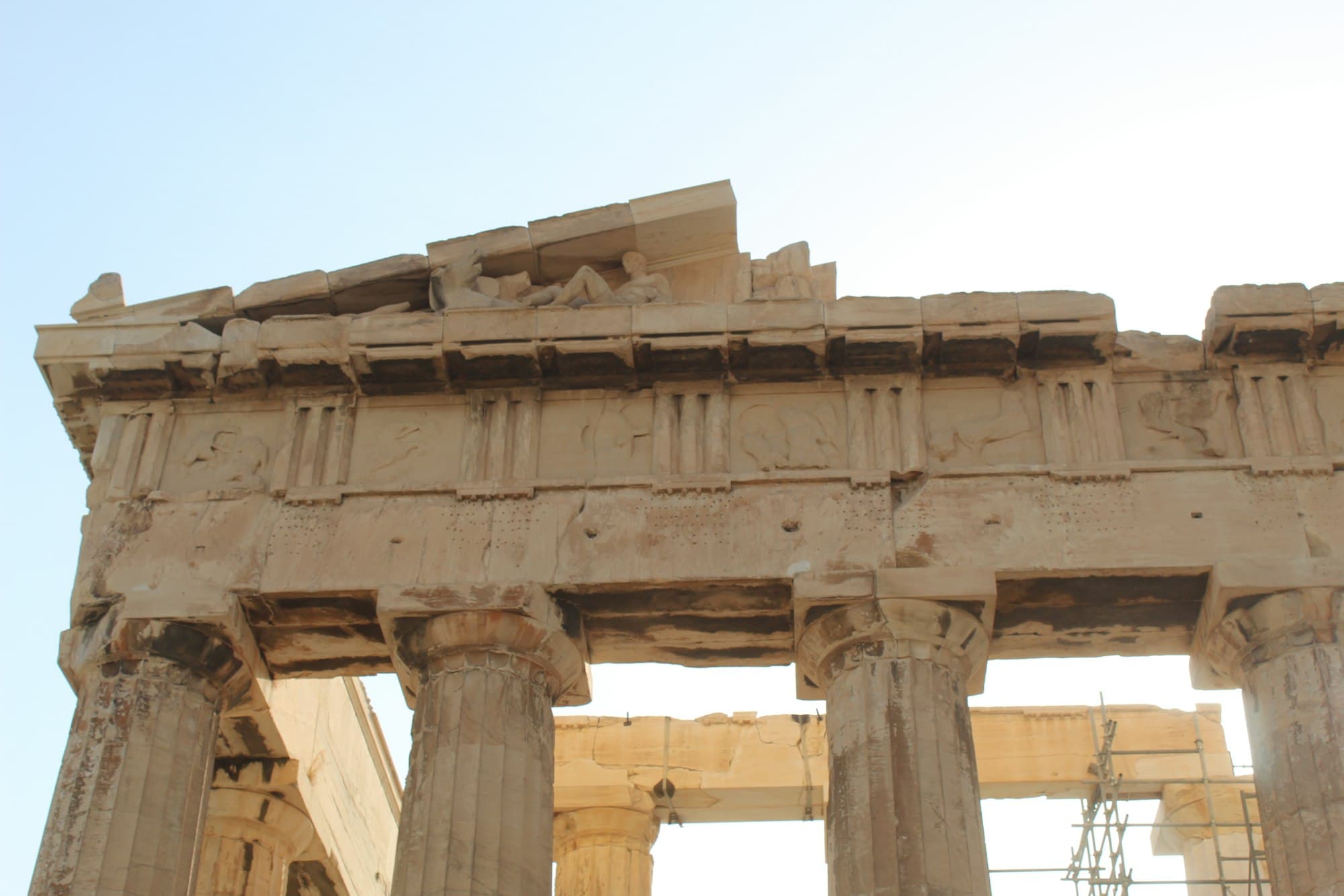 Parthenon columns and frieze against a bright sky