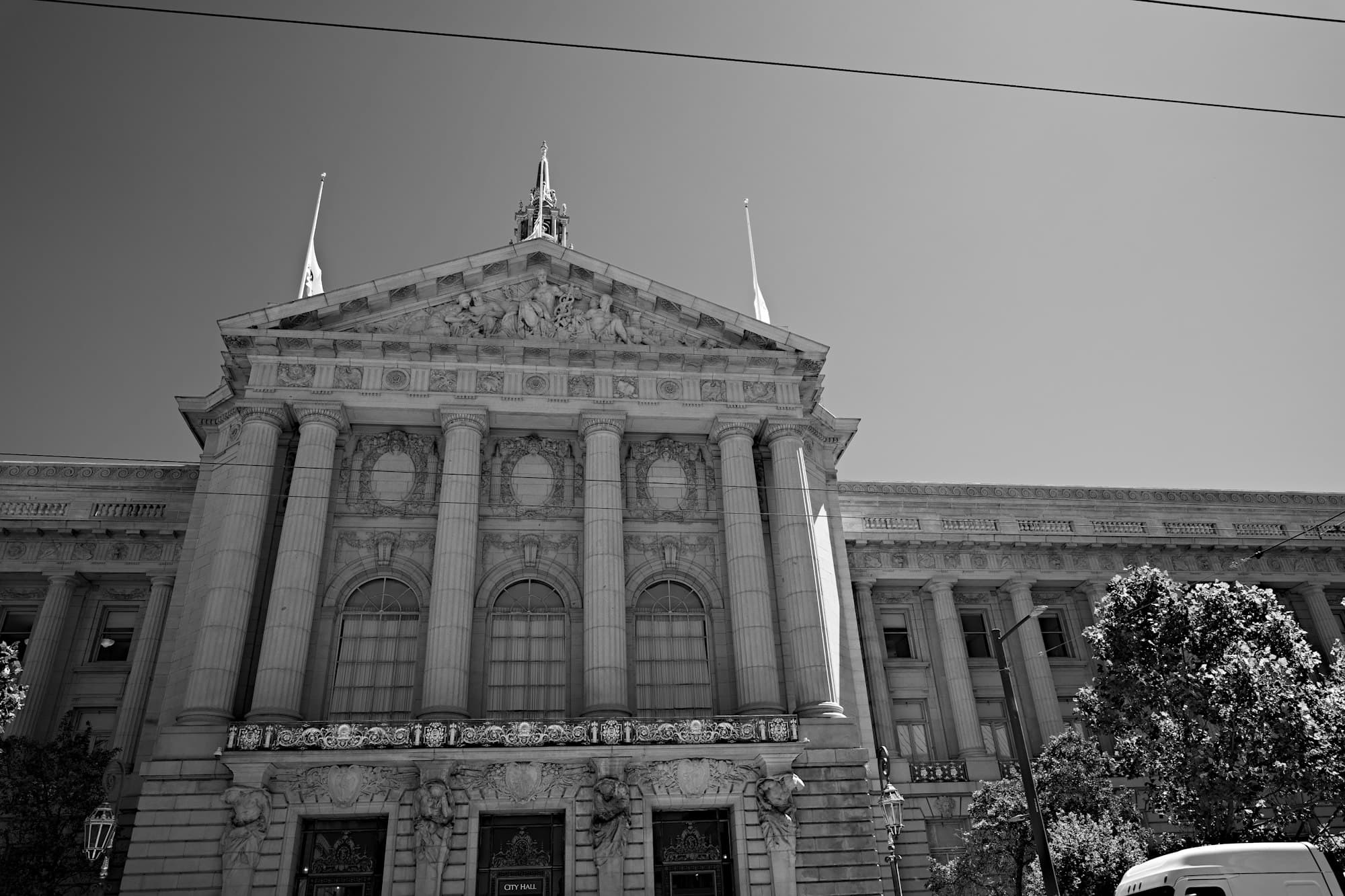 The neoclassical facade of a city hall with columns, in black and white